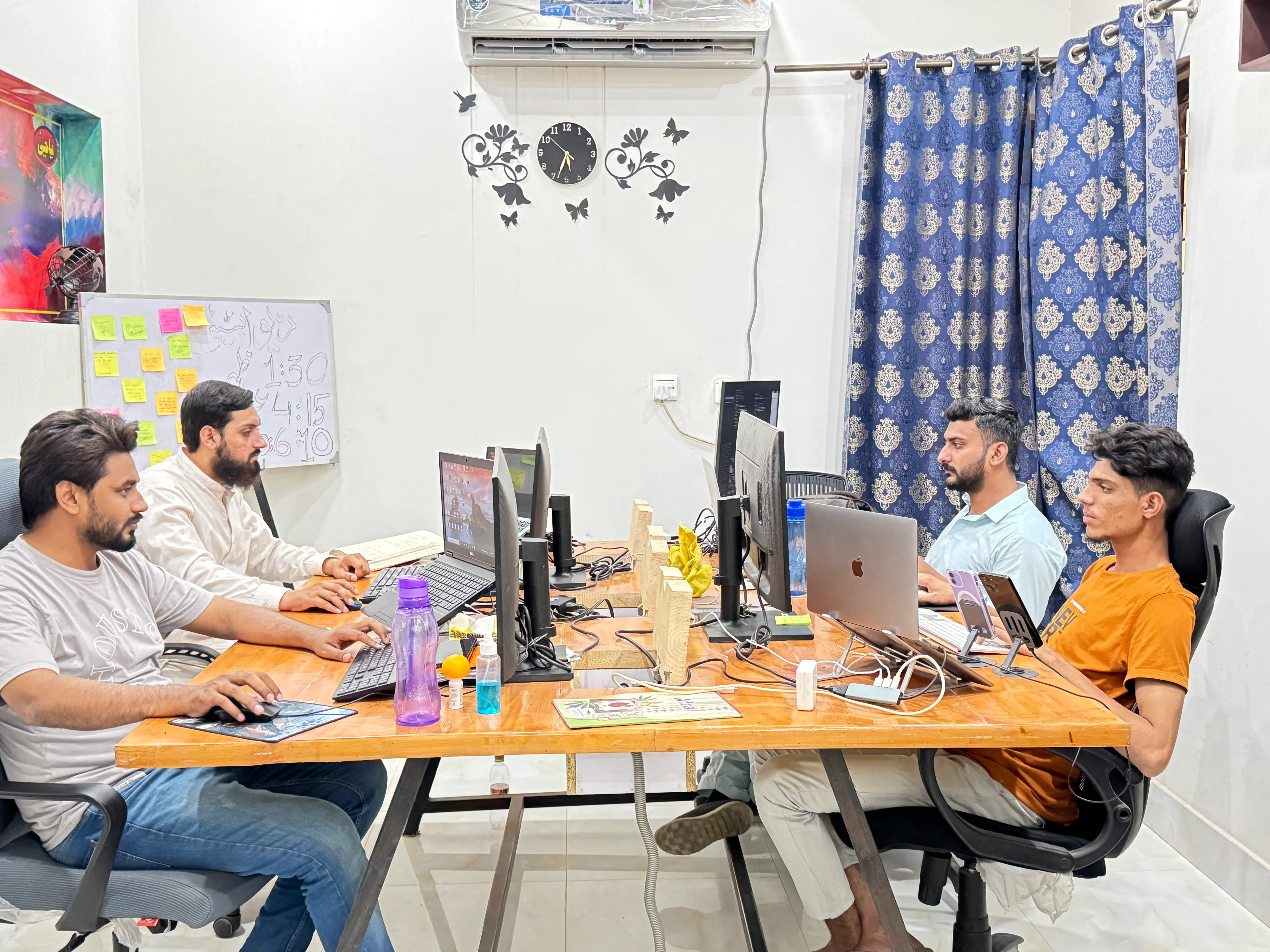 Dev Entity developers working together at the main office table